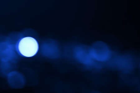 Abstract blurred blue bokeh lights backgroundの写真素材
