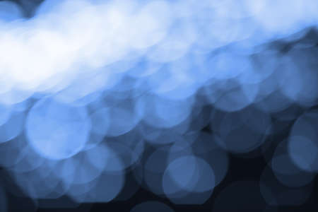 Abstract blurred blue bokeh lights backgroundの写真素材