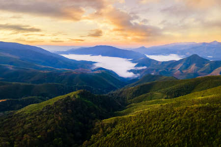 Majestic fog in the mountains landscape. Beautiful white misty landscape mountain at Ban Huai Thon in the region of Nan , Thailand.の写真素材
