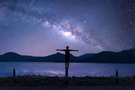 Silhouette of relax man standing with beautiful night sky with stars and milky way. Landscape Milky Wayの写真素材