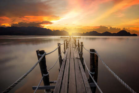 Beautiful sunset sky with wooden pier at Ao Talet (Ta Lhet) bay, Khanom, Nakhon Si Thammarat, Thailand. Travel, Landmark, Destiantionsの写真素材
