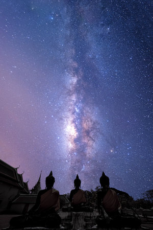 Beautiful milky way over Buddha statue in temple at Surat Thani, Thailand.の写真素材