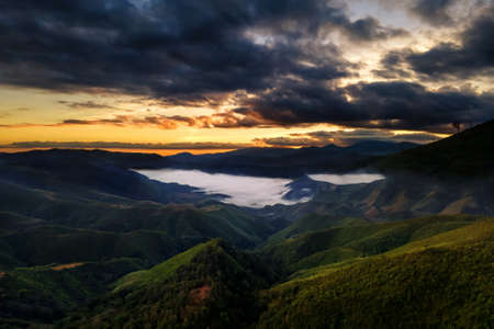 Beautiful view of white misty landscape mountain at Ban Huai Thon in the region of Nan , Thailand. Dramatic cloudscape. Rural scene.の写真素材