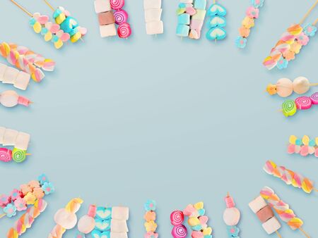 Colorful marshmallow sticks on blue backgroundの写真素材