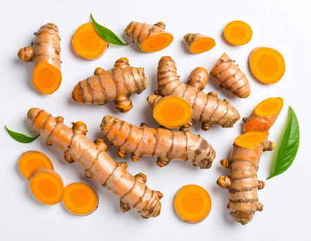 Fresh turmeric root and slices on white background. Top view.の素材