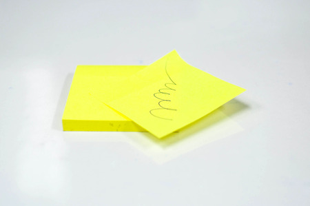 Yellow stick note isolated on white backgroundの写真素材