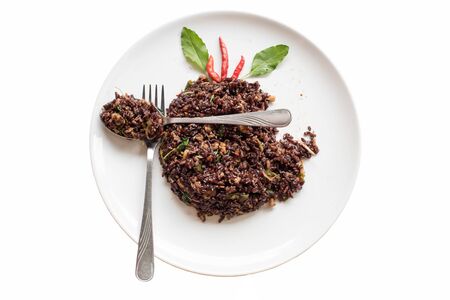 Basil fried riceberry rice mingled with minced pork on isolate backgroundの写真素材