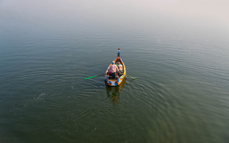 Boat with tourists at U-Bein Bridge in Amarapura , Mandalay , Myanmar