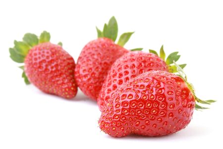 Four fresh strawberries isolated on white background.の写真素材