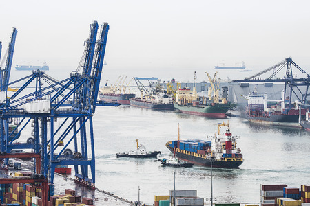 Container Cargo freight ship with working crane bridge in shipyard at dusk for Logistic Import Export backgroundの写真素材