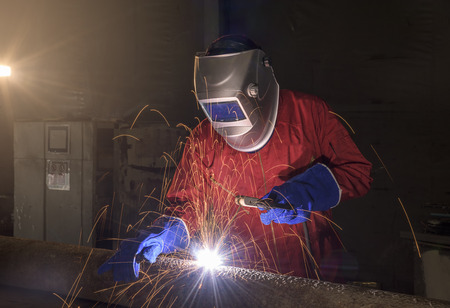 Industrial Worker at the factory welding closeup