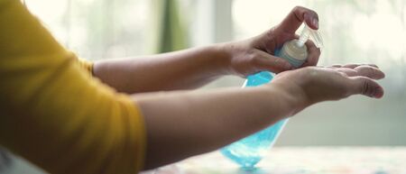 Banner of Chinese girl using alcohol gel for cleaning and hygienic her hand in virus covid 19...
