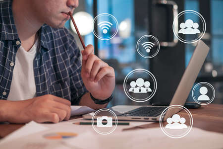 Man using Laptop connecting to social network in coffee shop, network communication conceptの写真素材