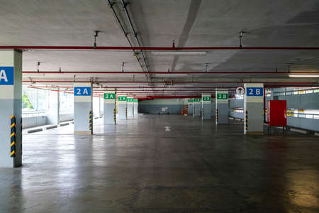 empty modern parking lot garage building in shopping mall because city lock down during coronavirus or covid-19 virus outbreak situation. transportation, coronavirus or city lockdown conceptsの写真素材