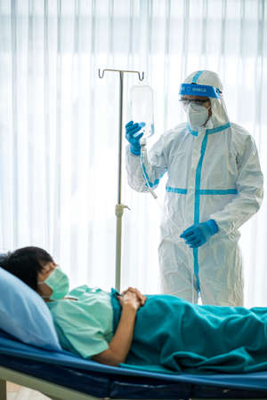 Portrait photo of Asian doctor wearing ppe suit and face mask in hospital. Corona virus, Covid-19,...