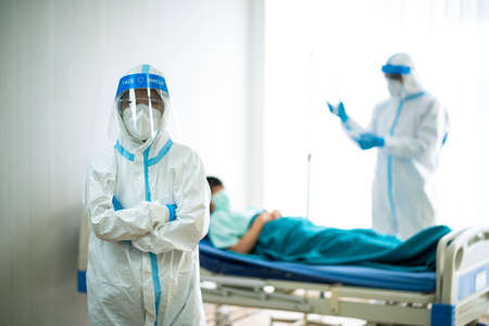 Portrait photo of Asian doctor wearing ppe suit and face mask in hospital. Corona virus, Covid-19, virus outbreak, medical mask, hospital, quarantine or virus outbreak conceptの写真素材