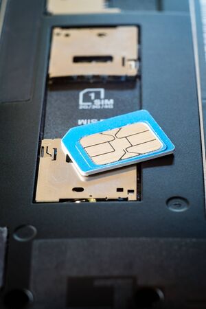 SIM card and dual sim slot on smart phone. selective focus.