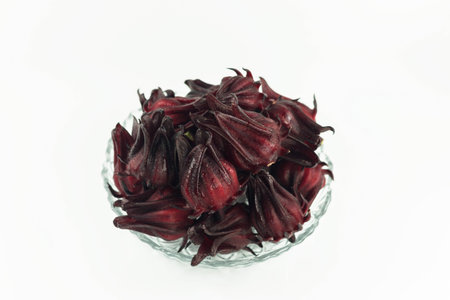 Hibiscus sabdariffa or Roselle fruits in a bowl on white backgroundの写真素材