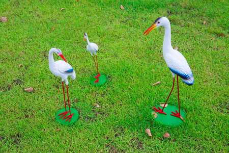 Flamingo garden ornaments in various places.の写真素材
