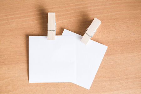 Paper note with clip on wooden floor Background 