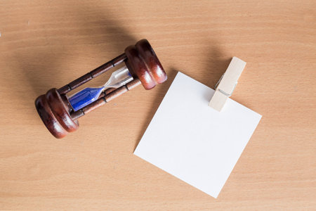 Paper note with clip on wooden floor Background の写真素材