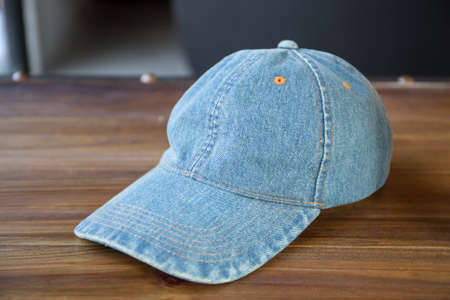 Denim cap on wooden backgroundの写真素材