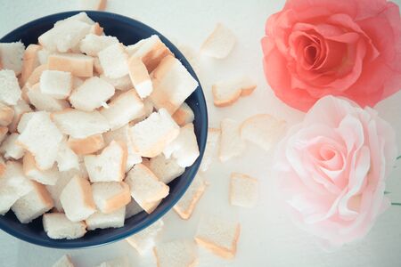 Bread was divided into pieces beautiful rose on white background.の写真素材