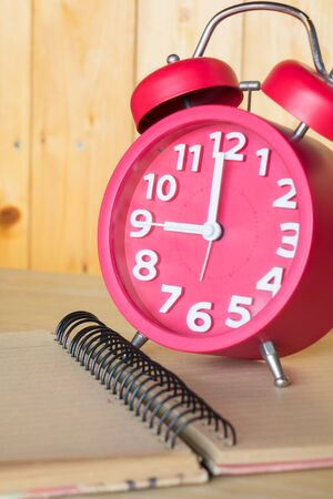 Alarm clock,on a book background.
