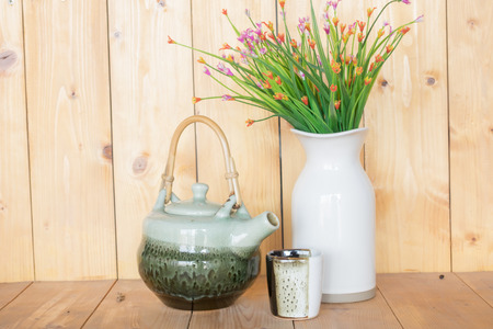 teapot and vase on a wooden background.の写真素材