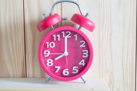 Alarm clock 
on wooden background.の写真素材
