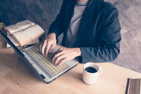 Businessman a computer laptop with a book hot coffee.