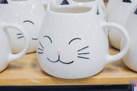 Glass cup white cat face is a lot.の写真素材