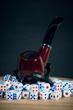 Smoking Tobacco Pipe with many diceの写真素材