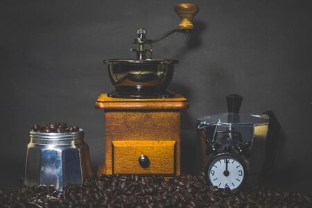 coffee grinder, coffee pot Coffee beans with Clock  alarm notebooks  on vintage backgroundの写真素材