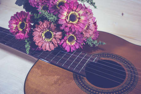 Acoustic guitar classic  resting against a wooden background with copy spaceの写真素材