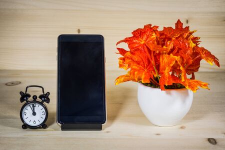 Wooden table with telephone, clock and the vase, then relax.