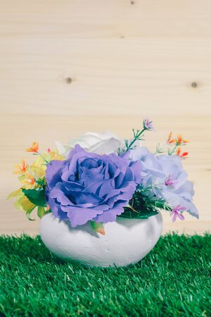 Beautiful fake flower vases on a grassy background.の写真素材