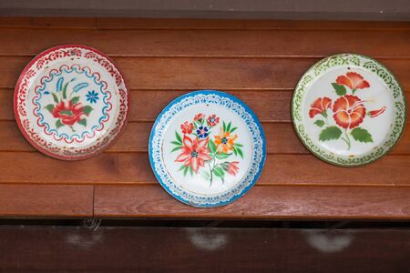Traditional food tray showcases prettiness on wooden walls.の写真素材