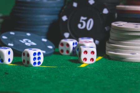 Dice ,Poker Chips Multicolor with a green backgroundの写真素材