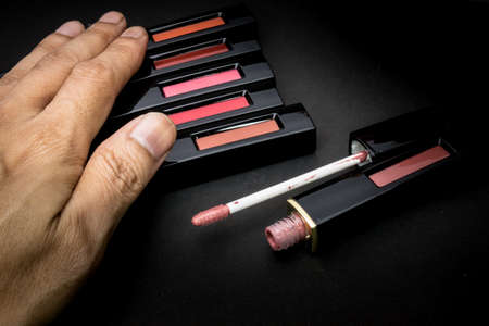 Lipstick and flowers with cosmetics for women To make her look beautiful at work on a black...