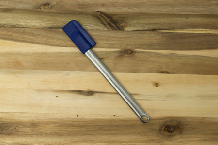 Narrow Spatula on hardwood butcher block cutting boardの写真素材