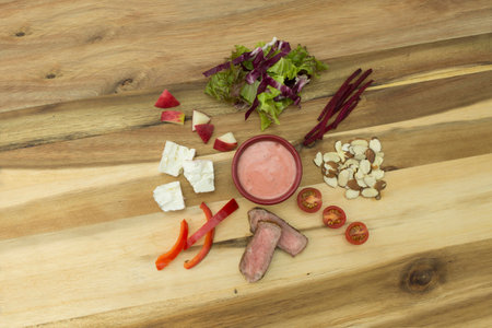Steak, Beet & Apple Salad with Raspberry Vinaigrette Dressing salad ingredient on cutting board, overhead shotの写真素材