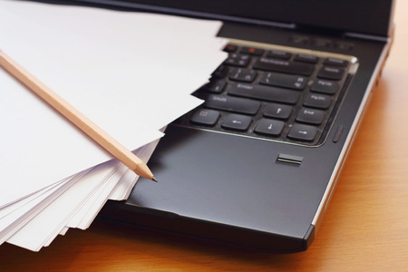 Paper and pencil on the black notebookの写真素材