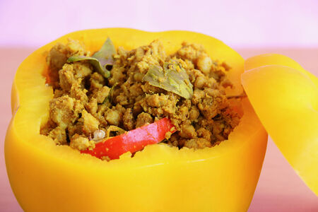 Pork with yellow curry paste in  sweet pepper on the tableの写真素材