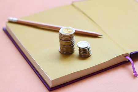pencil and money on a bookの写真素材