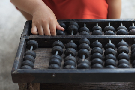 Child's hand playing abacus close up
の写真素材
