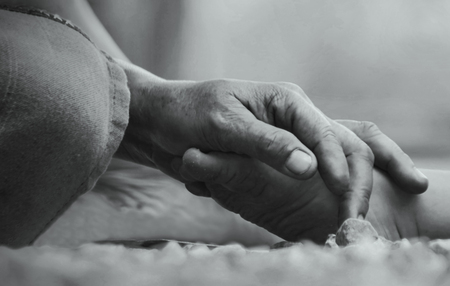 Hands of mother holding her baby foot black and whiteの写真素材