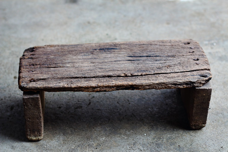 Old wooden stool on the cement floorの写真素材