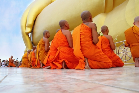 Ang Thong, Thailand-July 11,2014: Buddhists and monks walk with lighted candles clockwise round the temple, Asaha Puja Day and the beginning of Buddhist Lent, at Wat Muang- Ang Thong, Thailand.のeditorial素材
