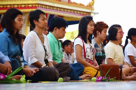 Ang Thong, Thailand-July 11,2014: Buddhists and monks meditation round the temple, in Asaha Puja Day and the beginning of Buddhist Lent, at Wat Muang- Ang Thong, Thailand.のeditorial素材